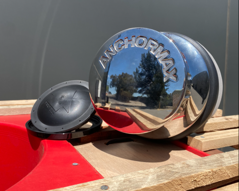 A close up of the side of a boat with a cap on it