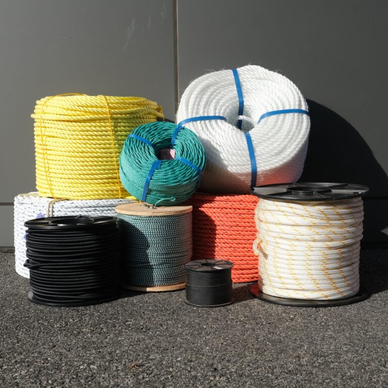 A group of different types of ropes on the ground.