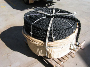 A large black rope in a wooden box.