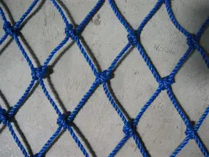 A blue rope net on concrete ground.