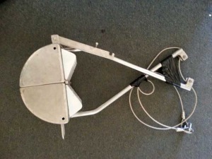 A white television antenna sitting on top of the floor.