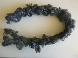 A black lei is laying on the table.